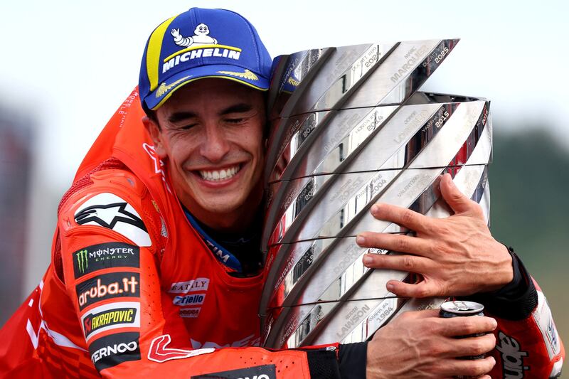 Marc Marquez celebrates with the trophy after winning the 2025 MotoGP World Championship. Picture: REUTERS