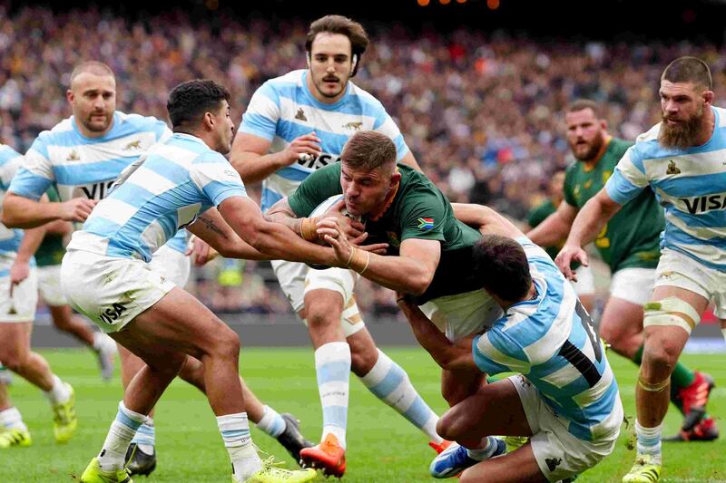 Malcolm Marx is tackled by Argentina’s Simon Benitez Cruz, left, and Bautista Delguy during the Rugby Championship match at Twickenham in London. Picture: BACKPAGEPIX